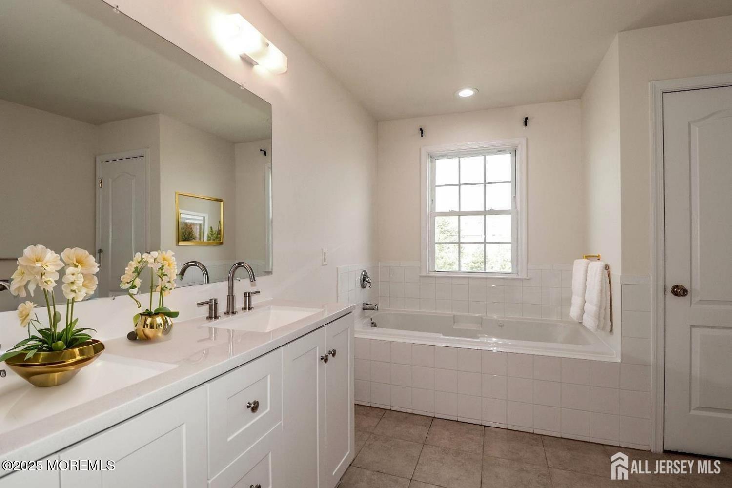 Undisclosed Address Monroe Township, NJ 08831 - Photo 9 of 10 a bathroom with a sink mirror and a bathtub