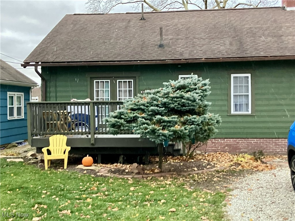 1006 Ridge Road Northwest Canton, OH 44703 - Photo 2 of 22 Rear view of house with a deck, roof with shingles, and a yard