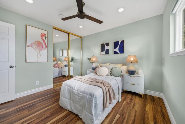 a bedroom with a bed and a painting on the wall