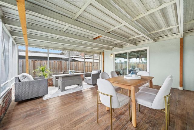a dining room with furniture and wooden floor