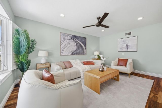 a living room with furniture and a large window