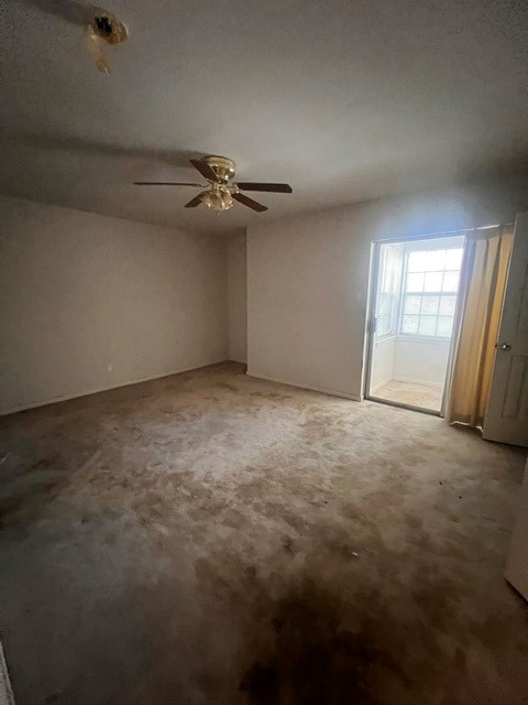 6304 South Rice Avenue Bellaire, TX 77401 - Photo 8 of 16 an empty room with windows and fan