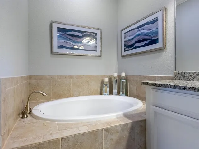 an aerial view of residential houses with outdoor space and ocean view