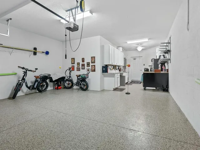 a view of a patio with a table and chairs under an umbrella