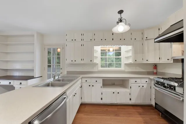 a kitchen with a sink stove and cabinets