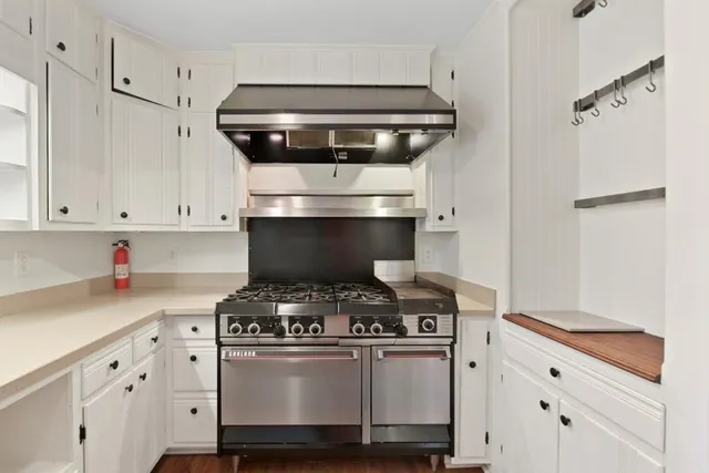 a stove top oven sitting inside of a kitchen