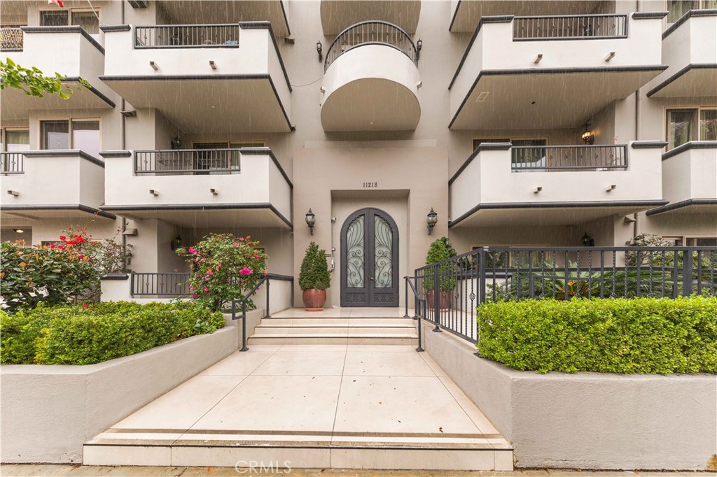 11218 Camarillo Street, Unit 404 Toluca Lake, CA 91602 - Photo 1 of 53 a front view of a house with garden