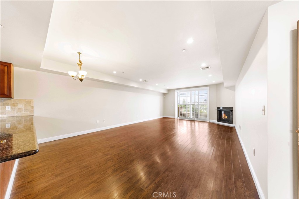 11218 Camarillo Street, Unit 404 Toluca Lake, CA 91602 - Photo 14 of 53 wooden floor in an empty room with a window