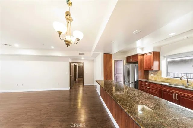 a large kitchen with stainless steel appliances granite countertop plenty wooden cabinets