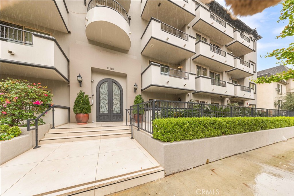 11218 Camarillo Street, Unit 404 Toluca Lake, CA 91602 - Photo 2 of 53 a front view of a house with garden