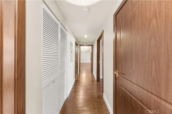 a view of a hallway with wooden floor