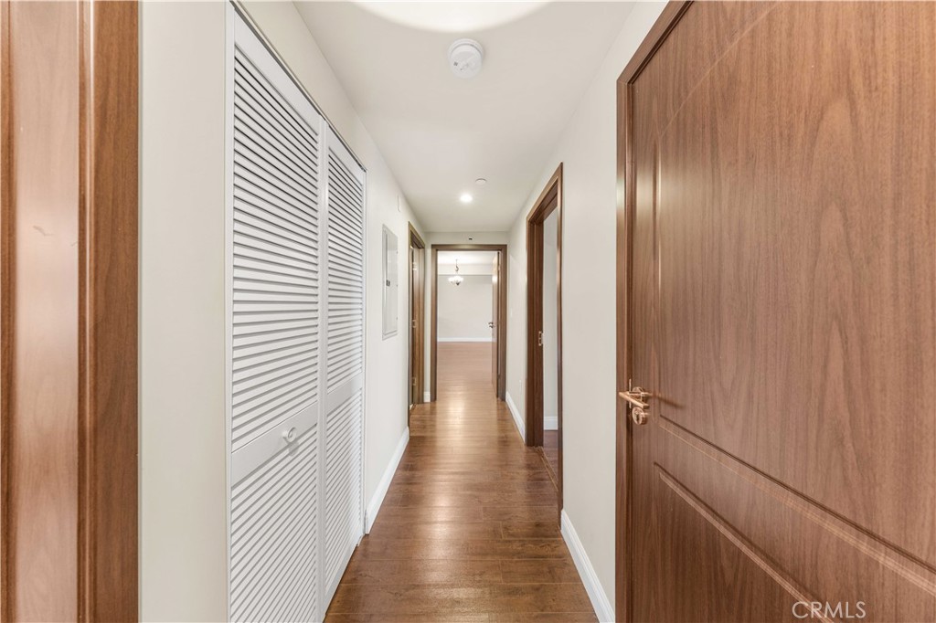 11218 Camarillo Street, Unit 404 Toluca Lake, CA 91602 - Photo 25 of 53 a view of a hallway with wooden floor