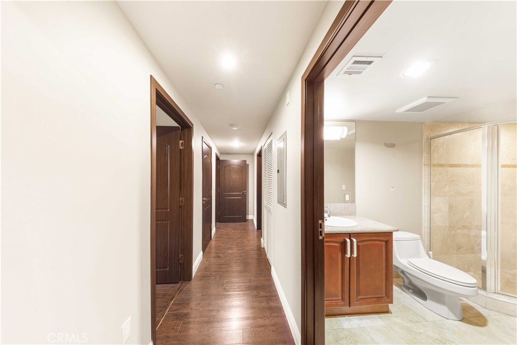11218 Camarillo Street, Unit 404 Toluca Lake, CA 91602 - Photo 26 of 53 a view of hallway with bathroom and wooden floor