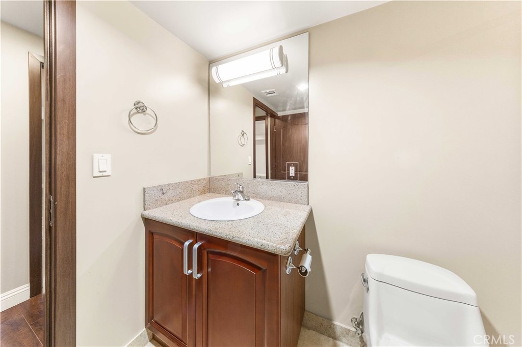 11218 Camarillo Street, Unit 404 Toluca Lake, CA 91602 - Photo 29 of 53 a bathroom with a sink toilet and mirror
