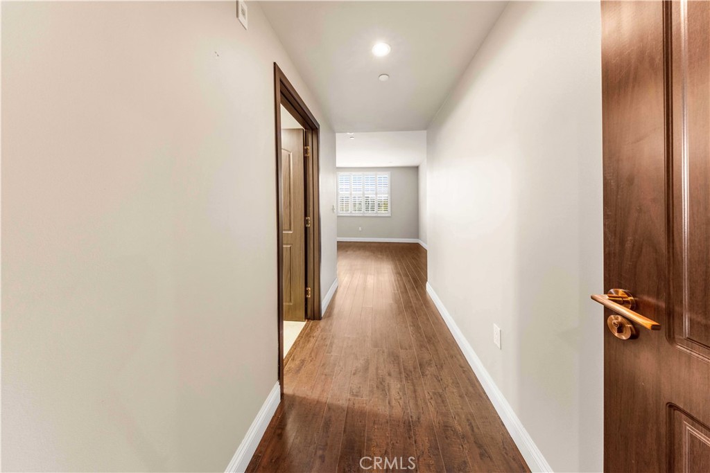 11218 Camarillo Street, Unit 404 Toluca Lake, CA 91602 - Photo 30 of 53 a view of a hallway with wooden floor