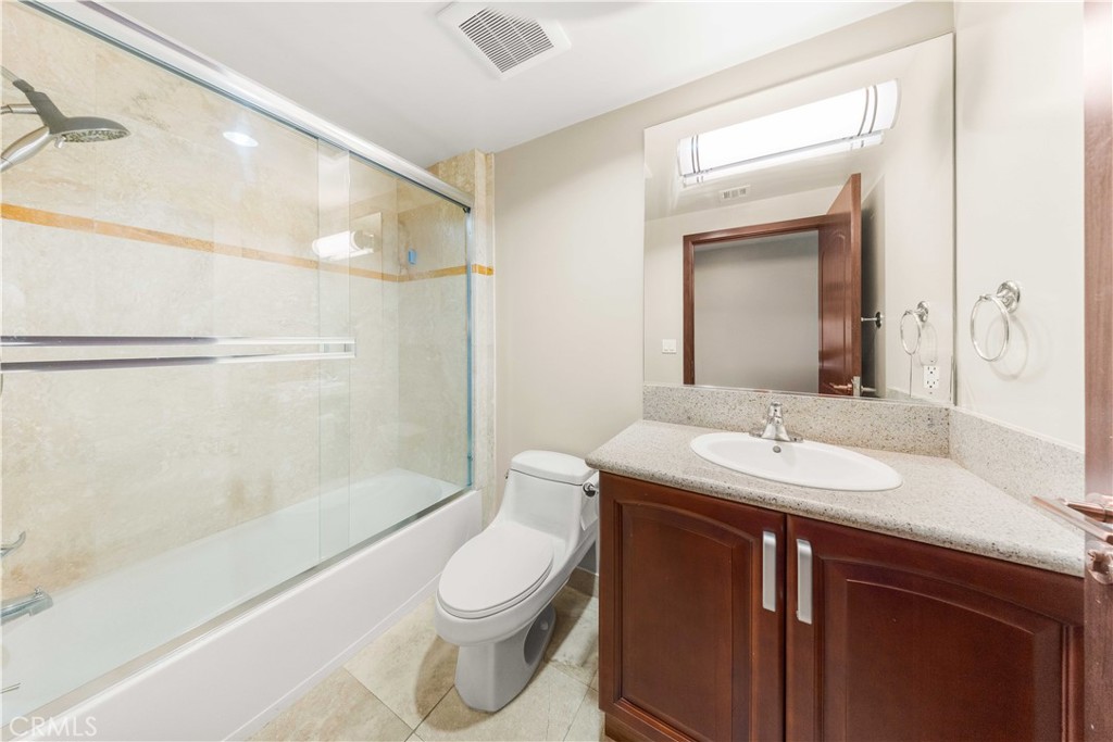 11218 Camarillo Street, Unit 404 Toluca Lake, CA 91602 - Photo 36 of 53 a bathroom with a sink a toilet and shower