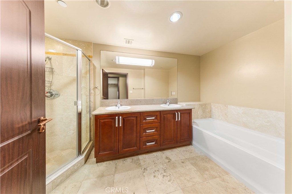 11218 Camarillo Street, Unit 404 Toluca Lake, CA 91602 - Photo 44 of 53 a bathroom with a tub sink shower and mirror