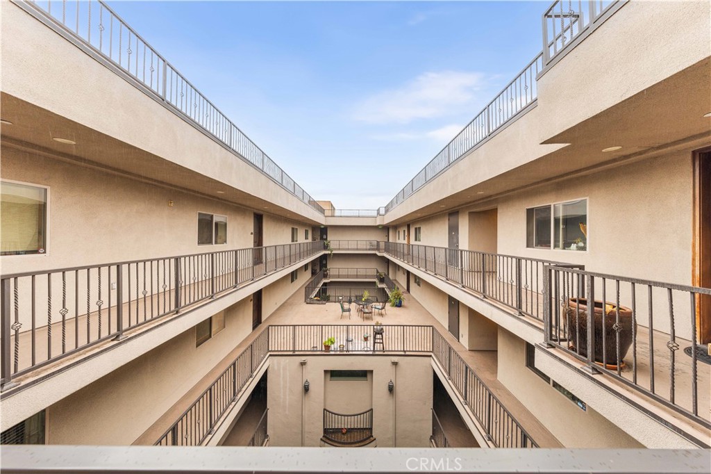 11218 Camarillo Street, Unit 404 Toluca Lake, CA 91602 - Photo 8 of 53 a view of balcony with wooden floor and white walls