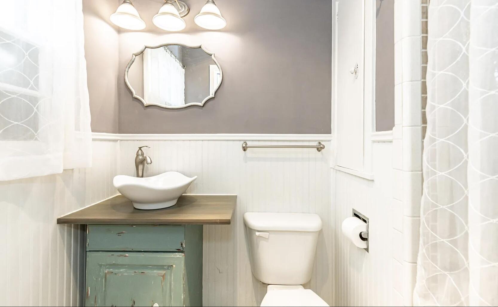 5424 14th Street Lubbock, TX 79416 - Photo 13 of 20 a bathroom with a sink and a mirror