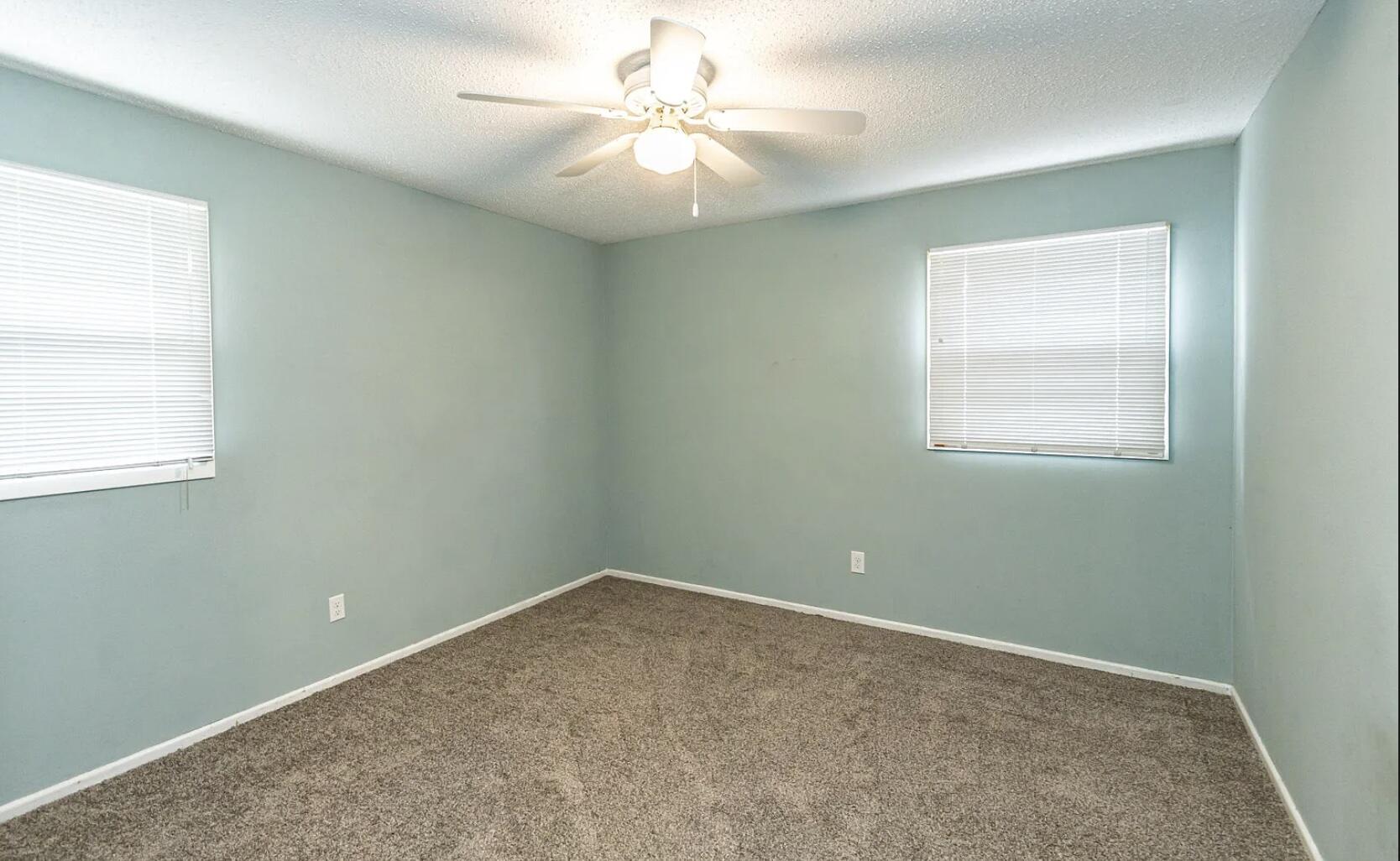 5424 14th Street Lubbock, TX 79416 - Photo 15 of 20 an empty room with a window and a fan