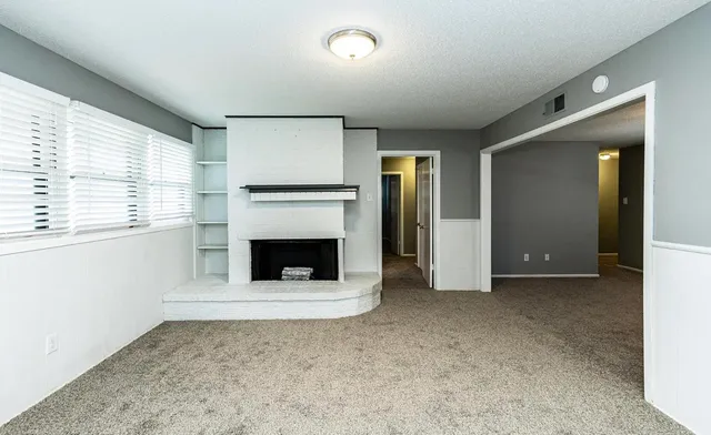 a view of a livingroom with an empty space and a fireplace
