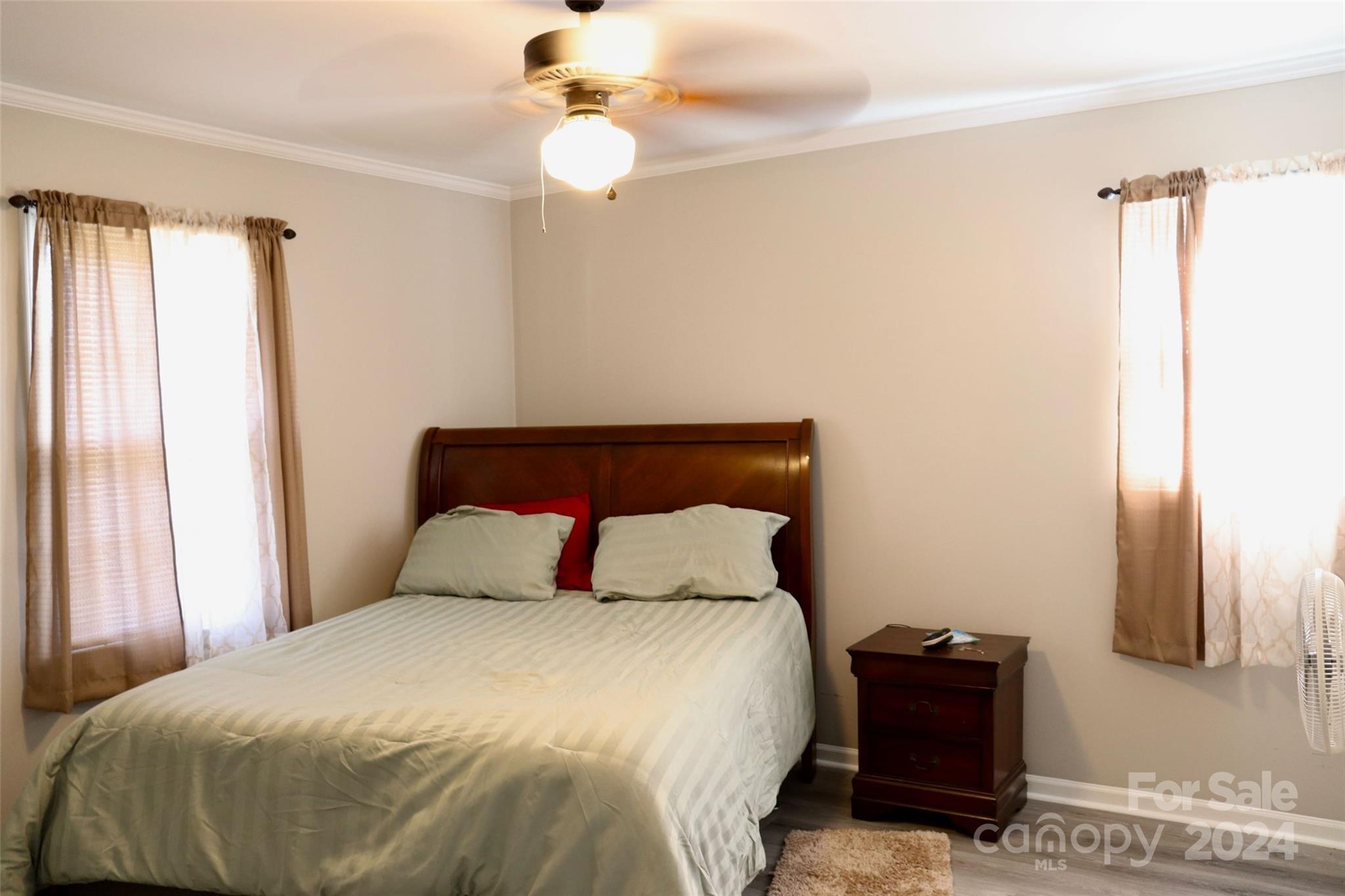 209 Old Williams Road Wingate, NC 28174 - Photo 11 of 13 a bedroom with a bed and a chandelier