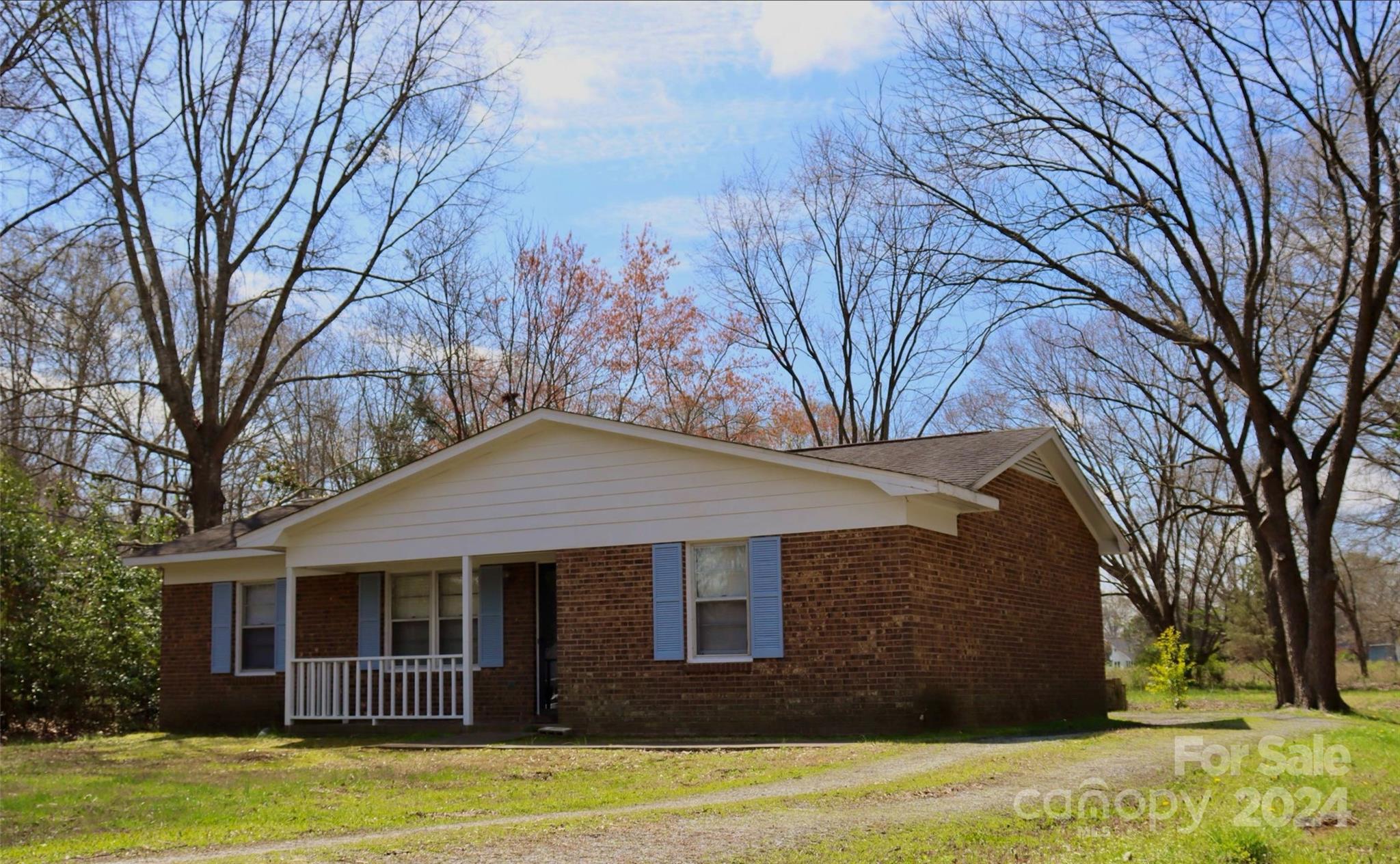 209 Old Williams Road Wingate, NC 28174 - Photo 2 of 13 a front view of a house with a garden