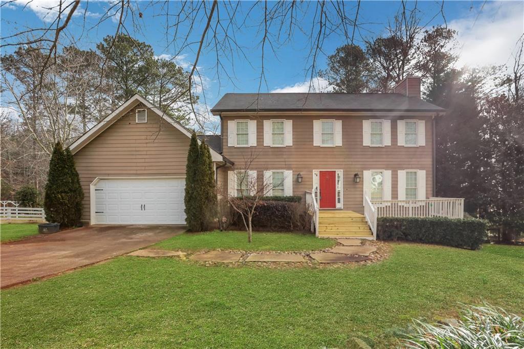 870 Springtime Drive Lawrenceville, GA 30043 - Photo 1 of 1 a front view of a house with a yard and garage