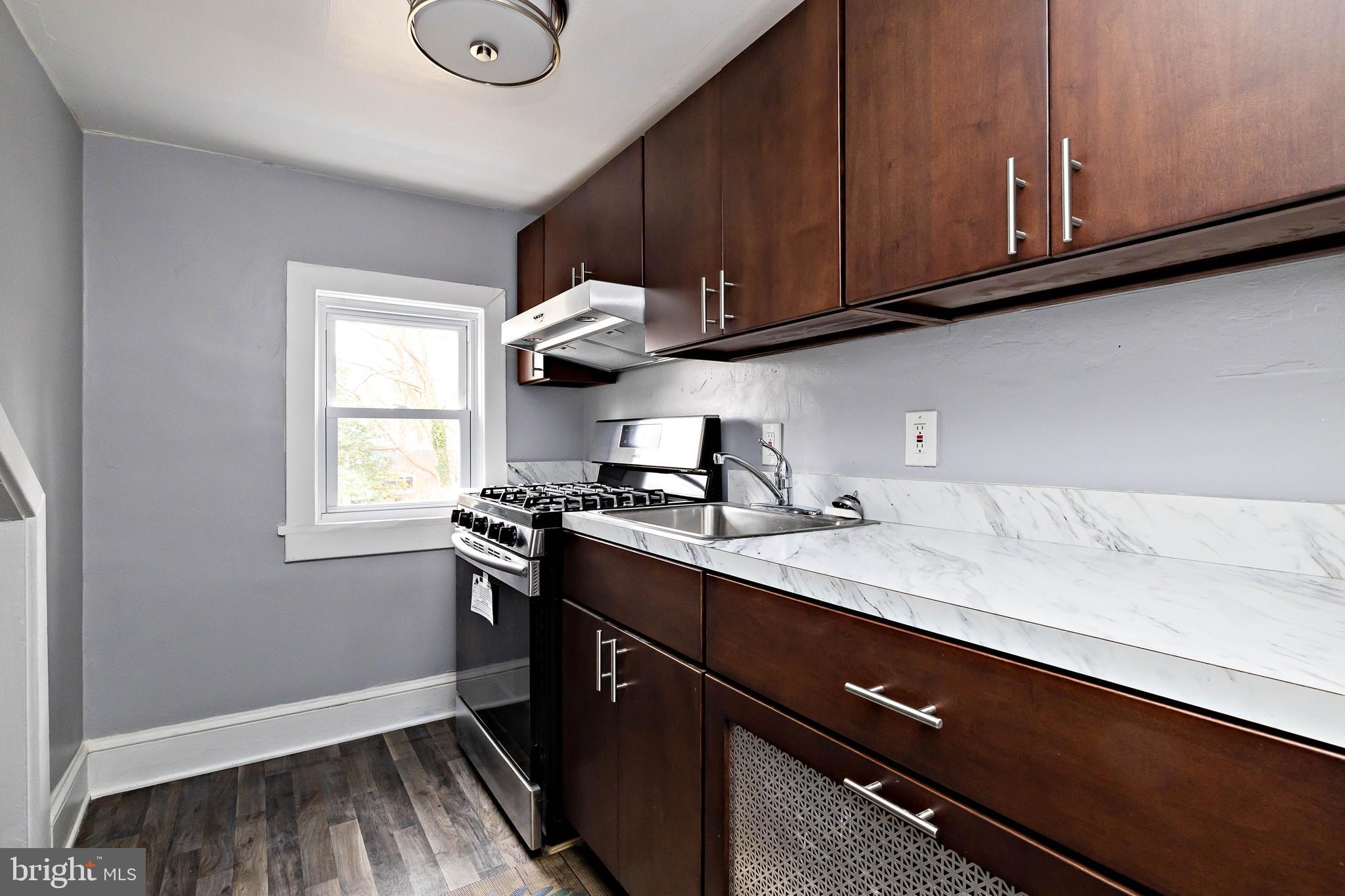 20 East Merchant Street, Unit C Audubon, NJ 08106 - Photo 16 of 26 a kitchen with a sink cabinets and window
