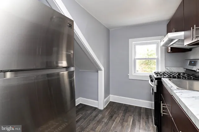 a kitchen with a sink a window and stainless steel appliances