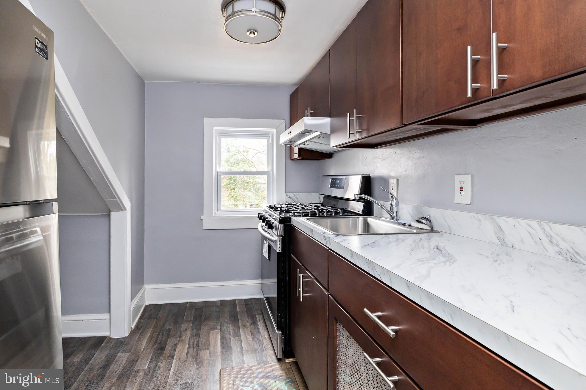 20 East Merchant Street, Unit C Audubon, NJ 08106 - Photo 20 of 26 a kitchen with a sink a stove and cabinets