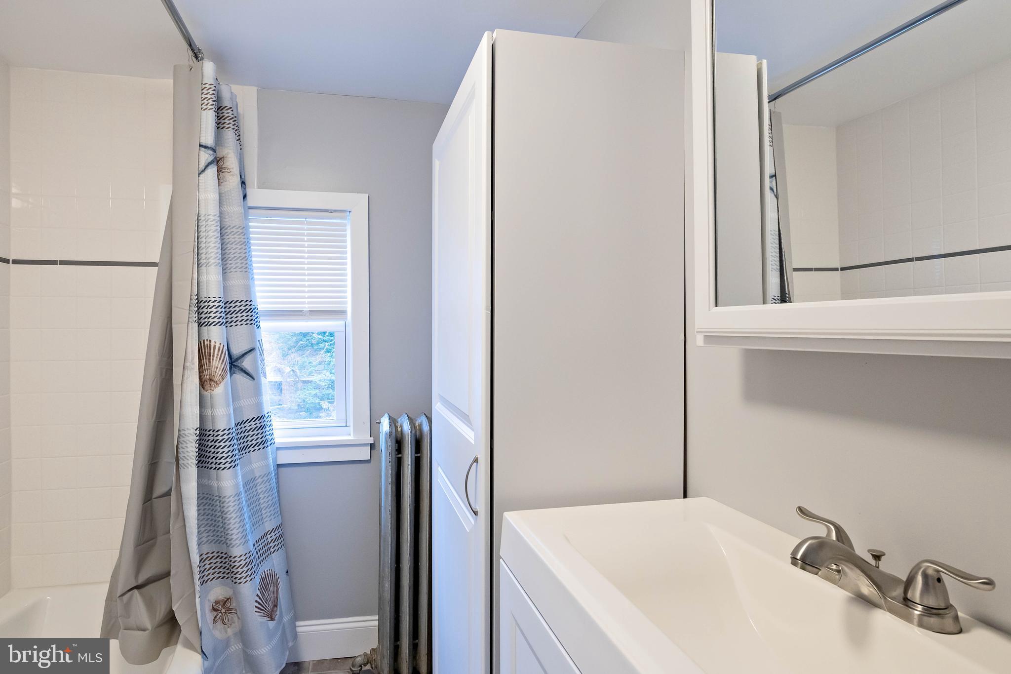 20 East Merchant Street, Unit C Audubon, NJ 08106 - Photo 25 of 26 a bathroom with a sink and a tub
