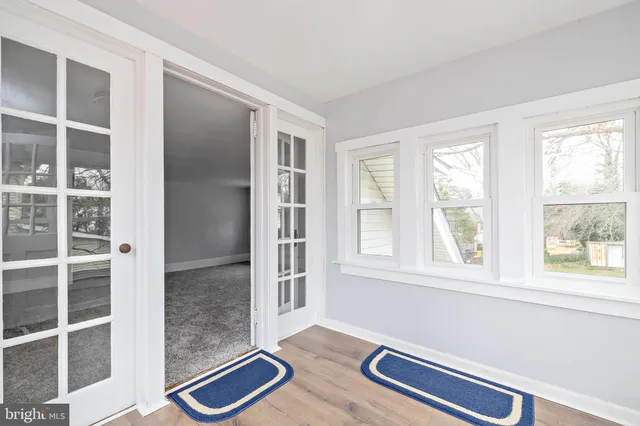 a view of room with window and wooden floor