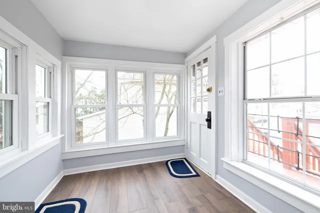 a view of a window and a livingroom with wooden floor