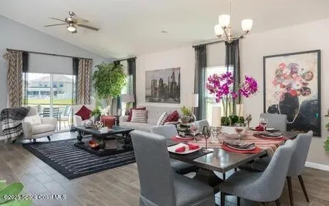 a living room with furniture a chandelier and a window