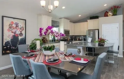 a dining room with furniture and a chandelier