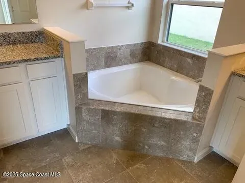 a bath tub sitting in a en suite bathroom