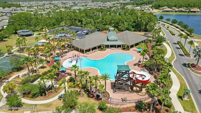 an aerial view of a house with outdoor space pool patio and lake view