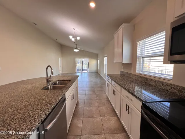 a kitchen with sink and window