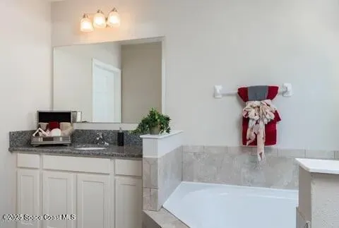 a bathroom with a tub sink and mirror