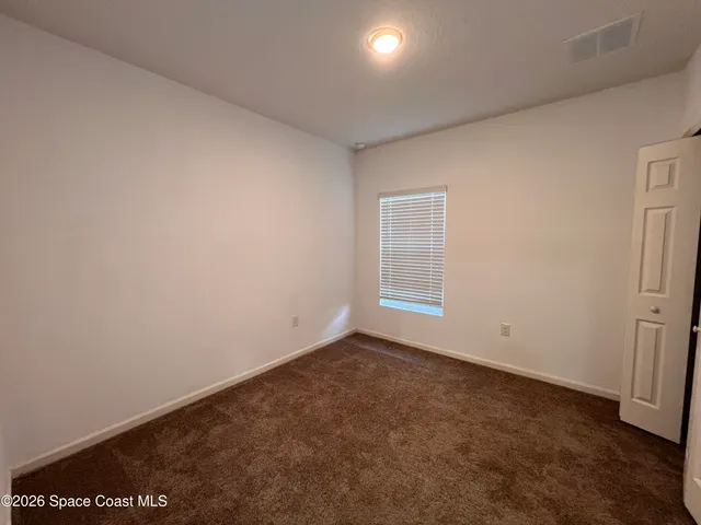 an empty room with a empty space and a window