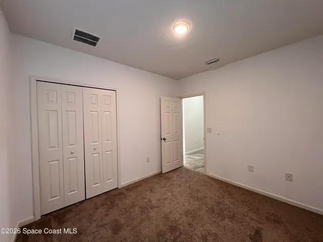 an empty room with closet area