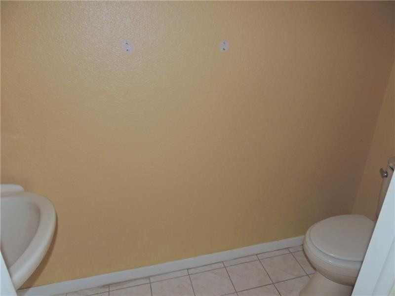 4112 Inverrary Drive, Unit 13F Lauderhill, FL 33319 - Photo 11 of 13 a bathroom with a toilet and a rug