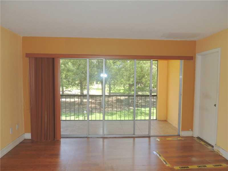 4112 Inverrary Drive, Unit 13F Lauderhill, FL 33319 - Photo 6 of 13 a view of empty room with wooden floor and fan