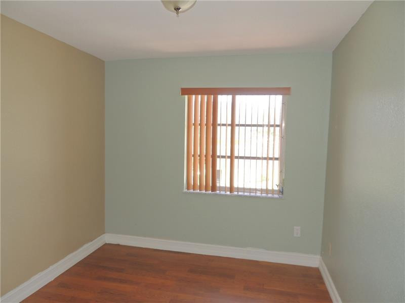 4112 Inverrary Drive, Unit 13F Lauderhill, FL 33319 - Photo 8 of 13 an empty room with wooden floor and windows
