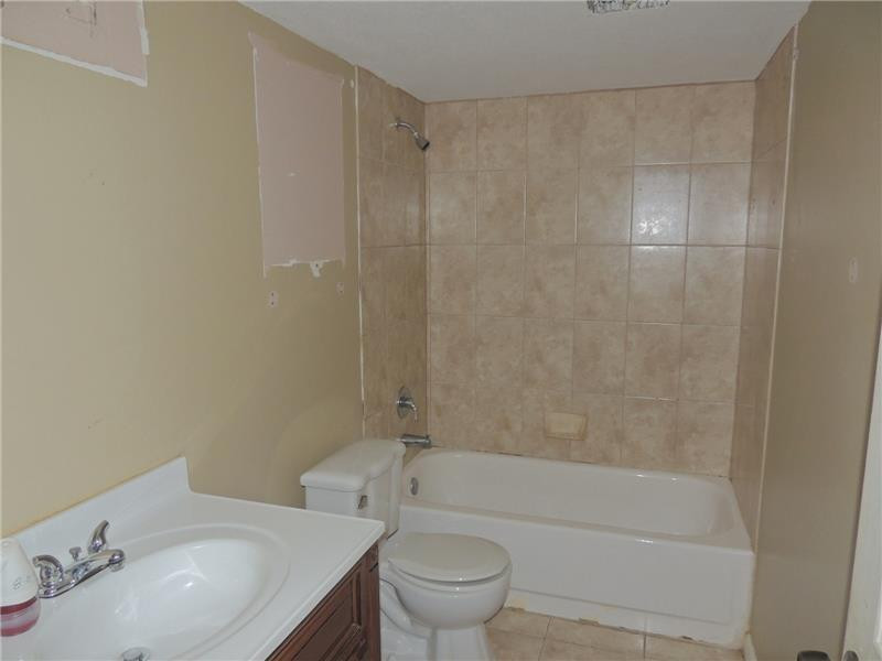 4112 Inverrary Drive, Unit 13F Lauderhill, FL 33319 - Photo 9 of 13 a bathroom with a bathtub shower sink mirror and toilet