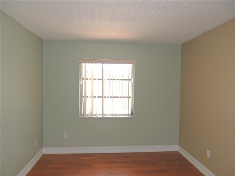 4112 Inverrary Drive, Unit 13F Lauderhill, FL 33319 - Photo 10 of 13 an empty room with wooden floor and windows