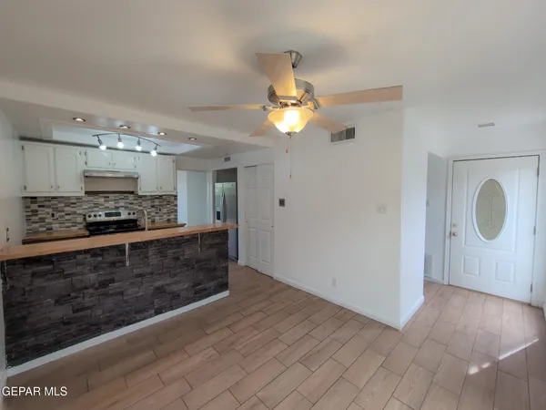 an empty room with wooden floor and fireplace