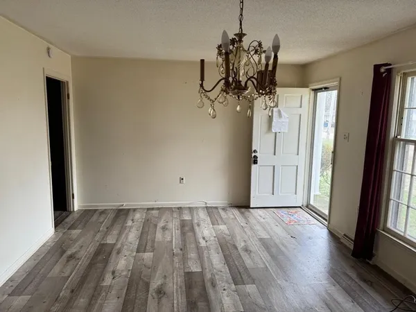 a view of a room with wooden floor and stairs