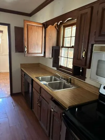 a kitchen with a stove a sink and a refrigerator